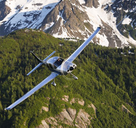 Plane flying over Alaska mountains. Links to Gifts That Pay You Income