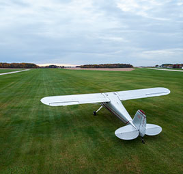 Photo of an airplane sitting on grass. Link to Beneficiary Designations.