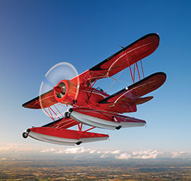 Photo of airplane flying. Link to Gifts That Protect Your Assets.